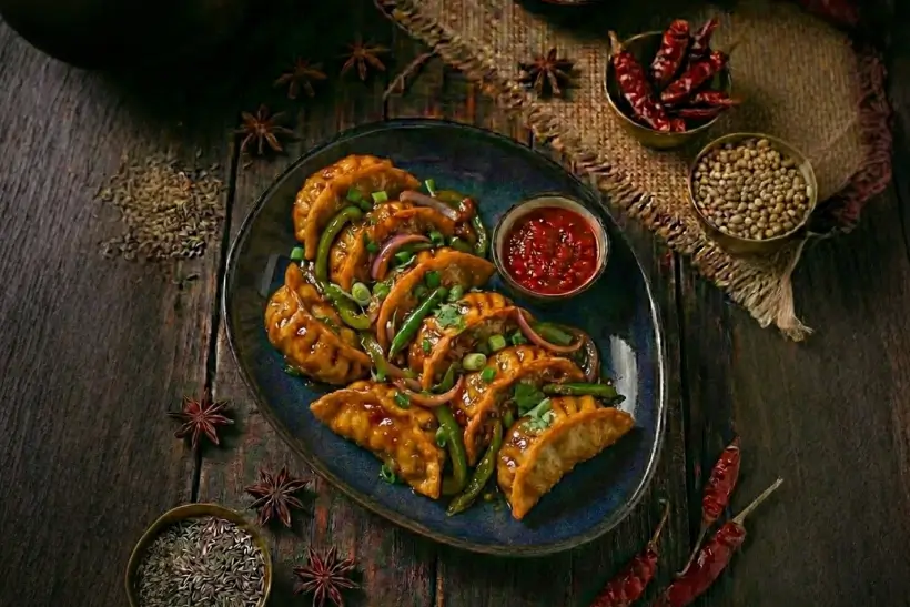 CHILI TOSSED MOMO (Choice of Veg / Non-Veg)